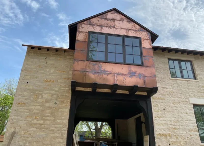 Copper metal panel facade on a stone building for Roof Repair in Golden Valley
